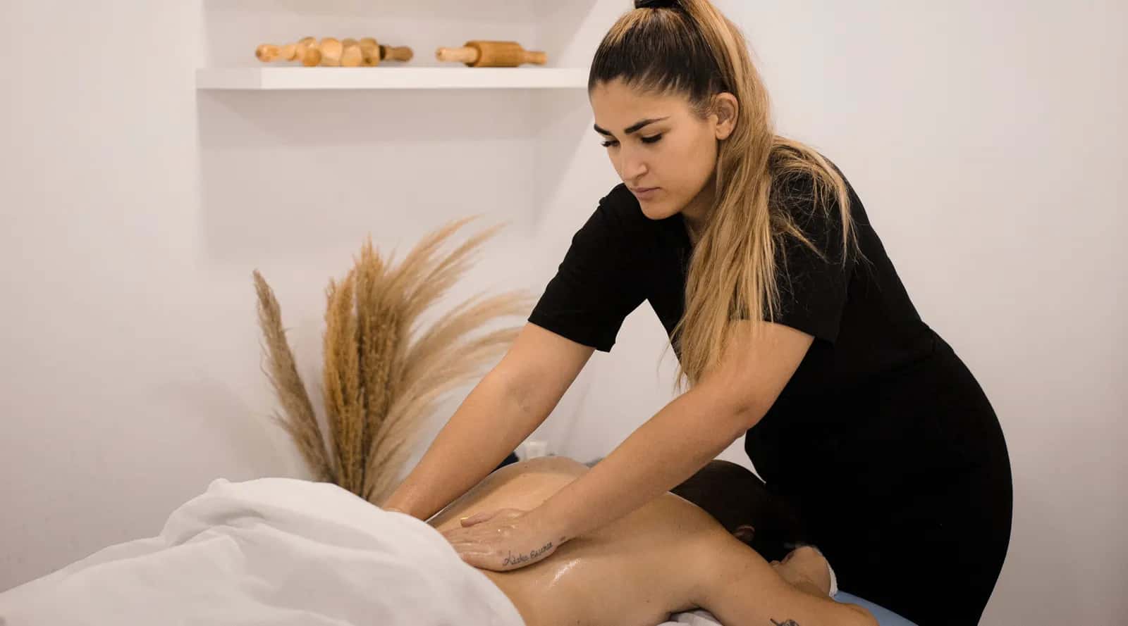 Marta giving a client a back massage in the Adara Essence treatment room